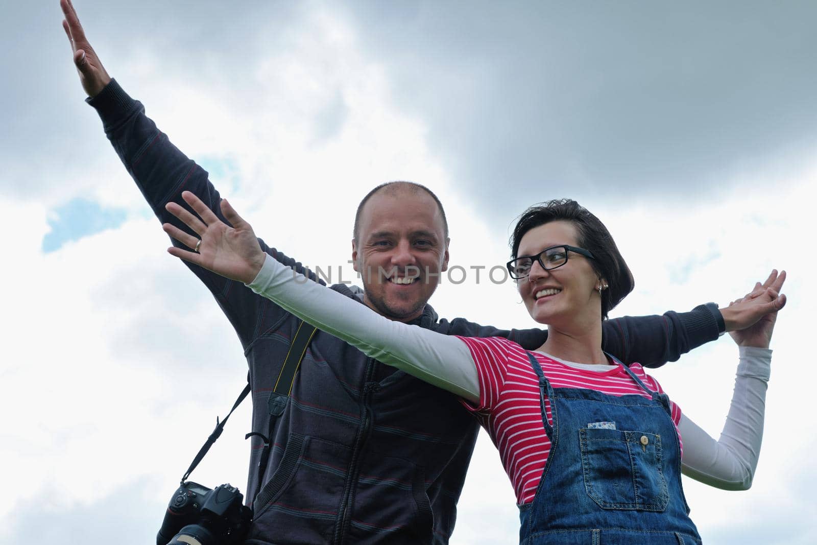 Portrait of romantic young couple in love  smiling together outdoor in nature with blue sky in background