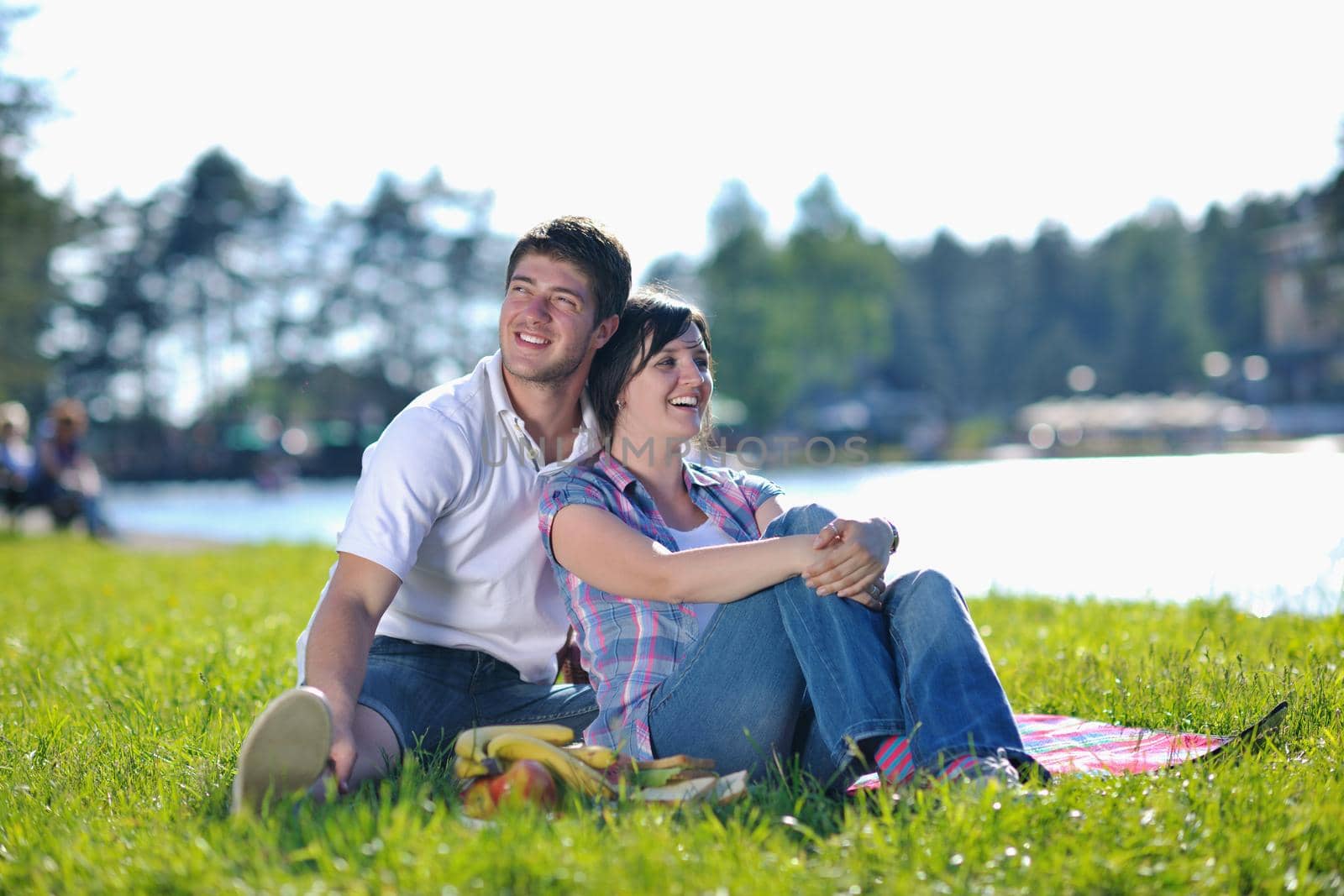 happy young romantic couple in love   having a picnic outdoor on a summer day