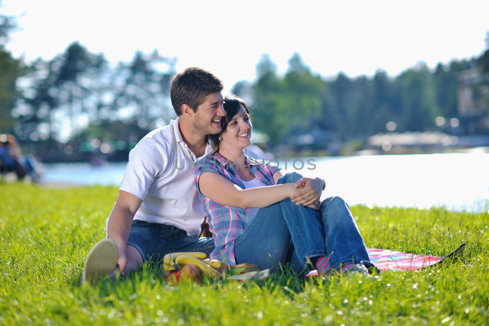 happy young romantic couple in love   having a picnic outdoor on a summer day