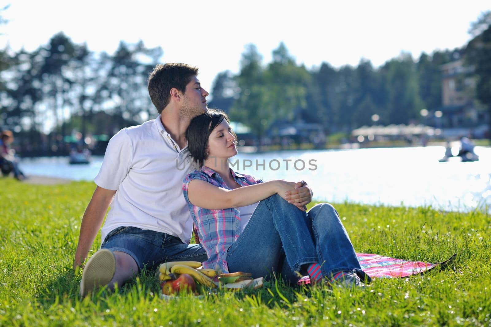 happy young romantic couple in love   having a picnic outdoor on a summer day