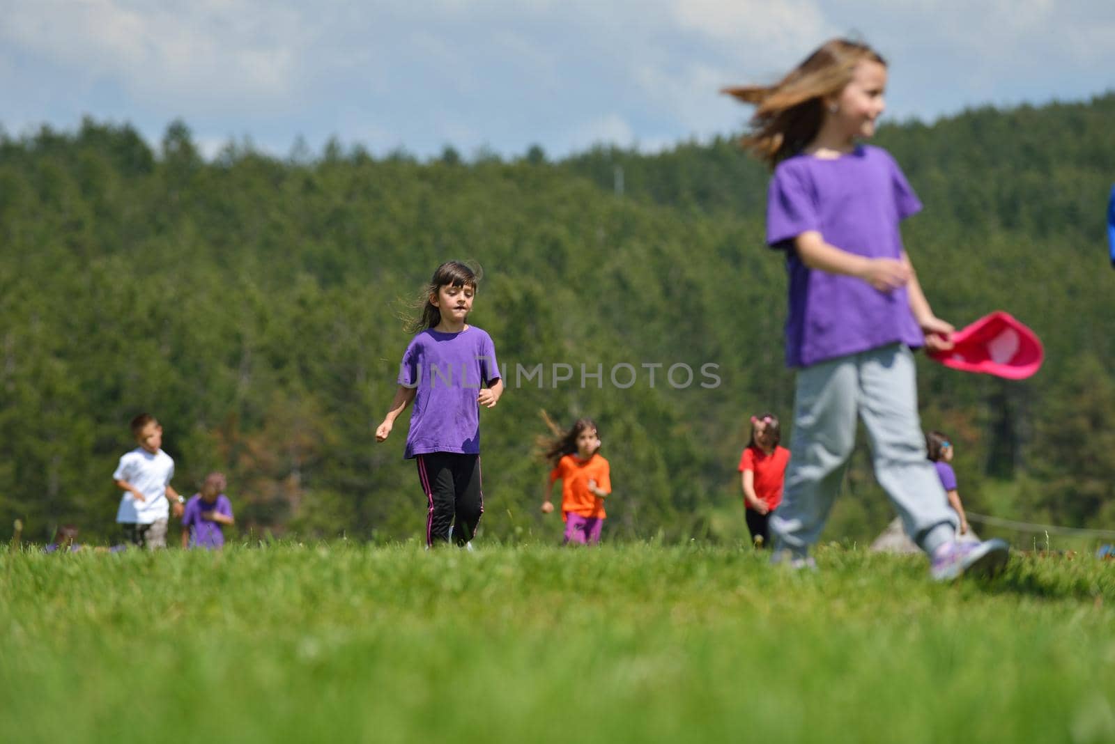 happy kids group have fun in nature outdoors park