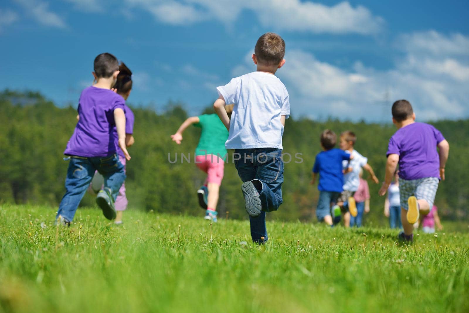 happy kids group have fun in nature outdoors park