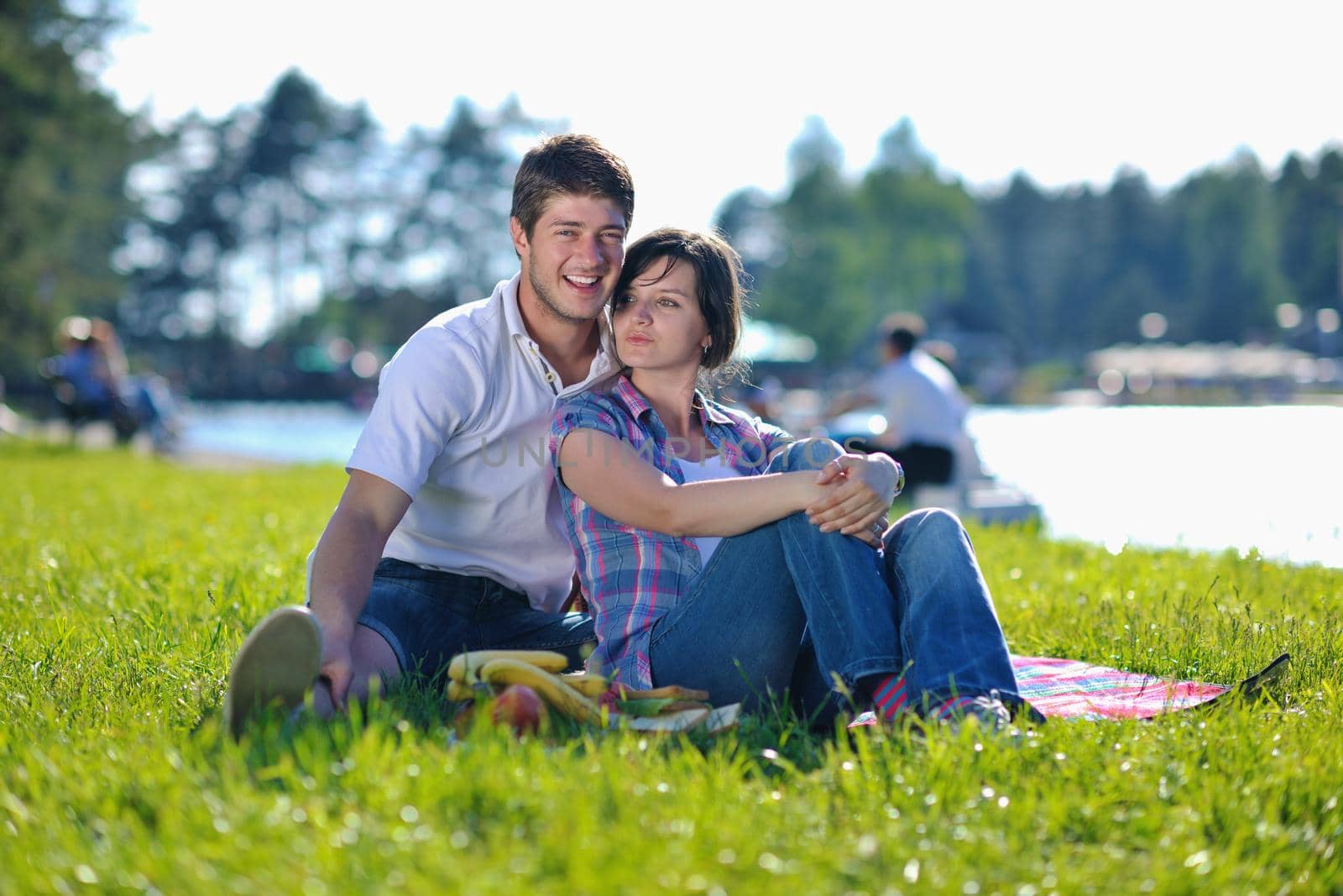 happy young romantic couple in love   having a picnic outdoor on a summer day