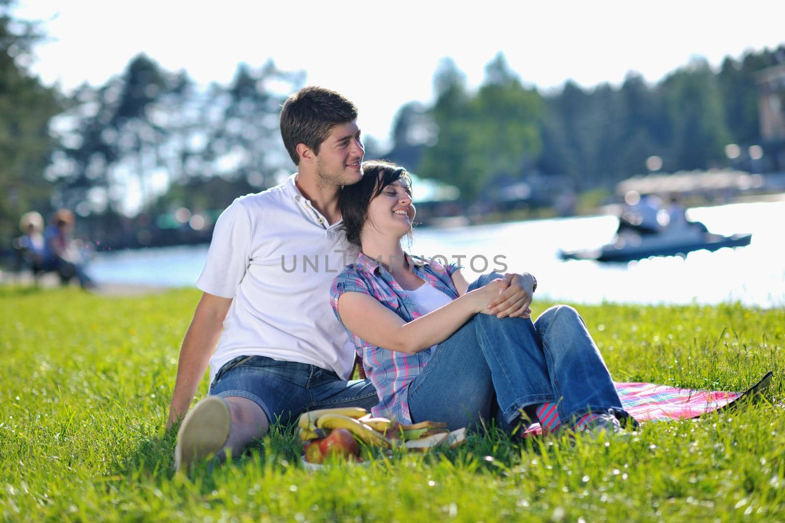 happy young romantic couple in love   having a picnic outdoor on a summer day