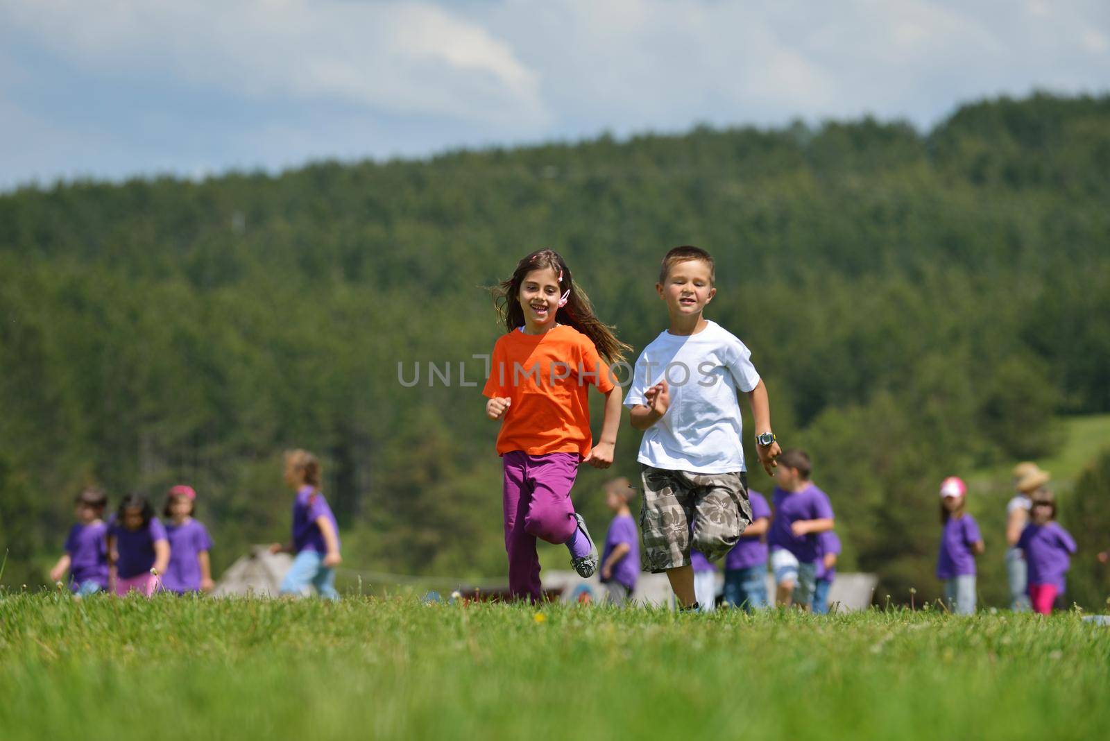 happy kids group have fun in nature outdoors park