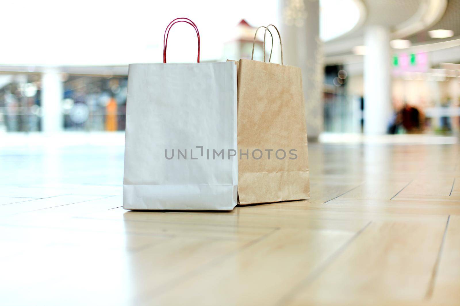 Paper shopping bags on floor at the mall. by tsyhun