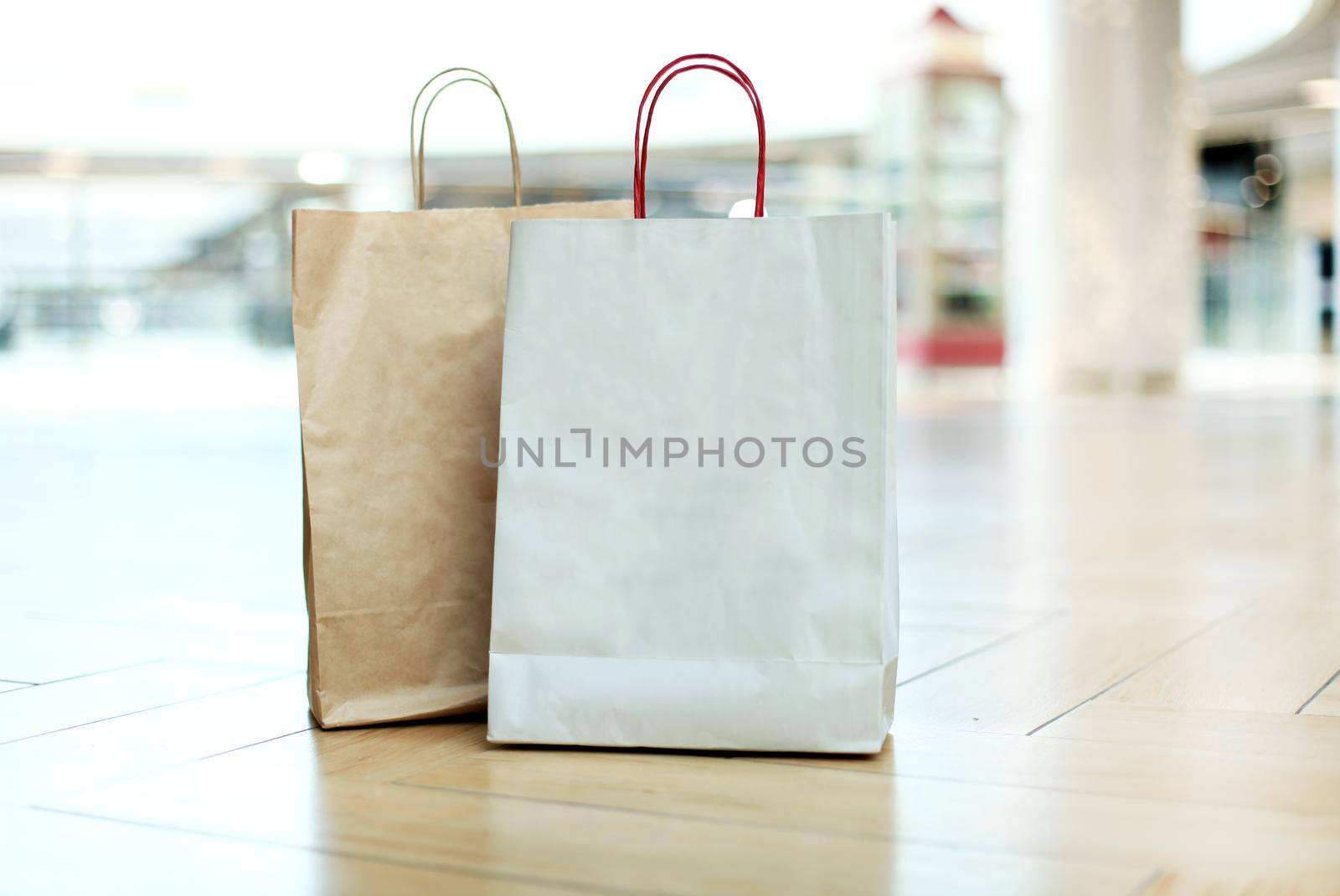 Paper shopping bags on floor at the mall.