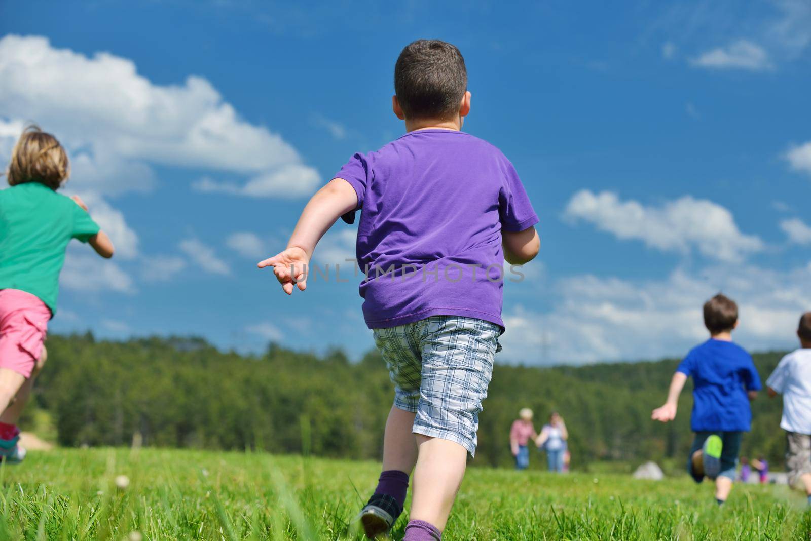 happy kids group have fun in nature outdoors park