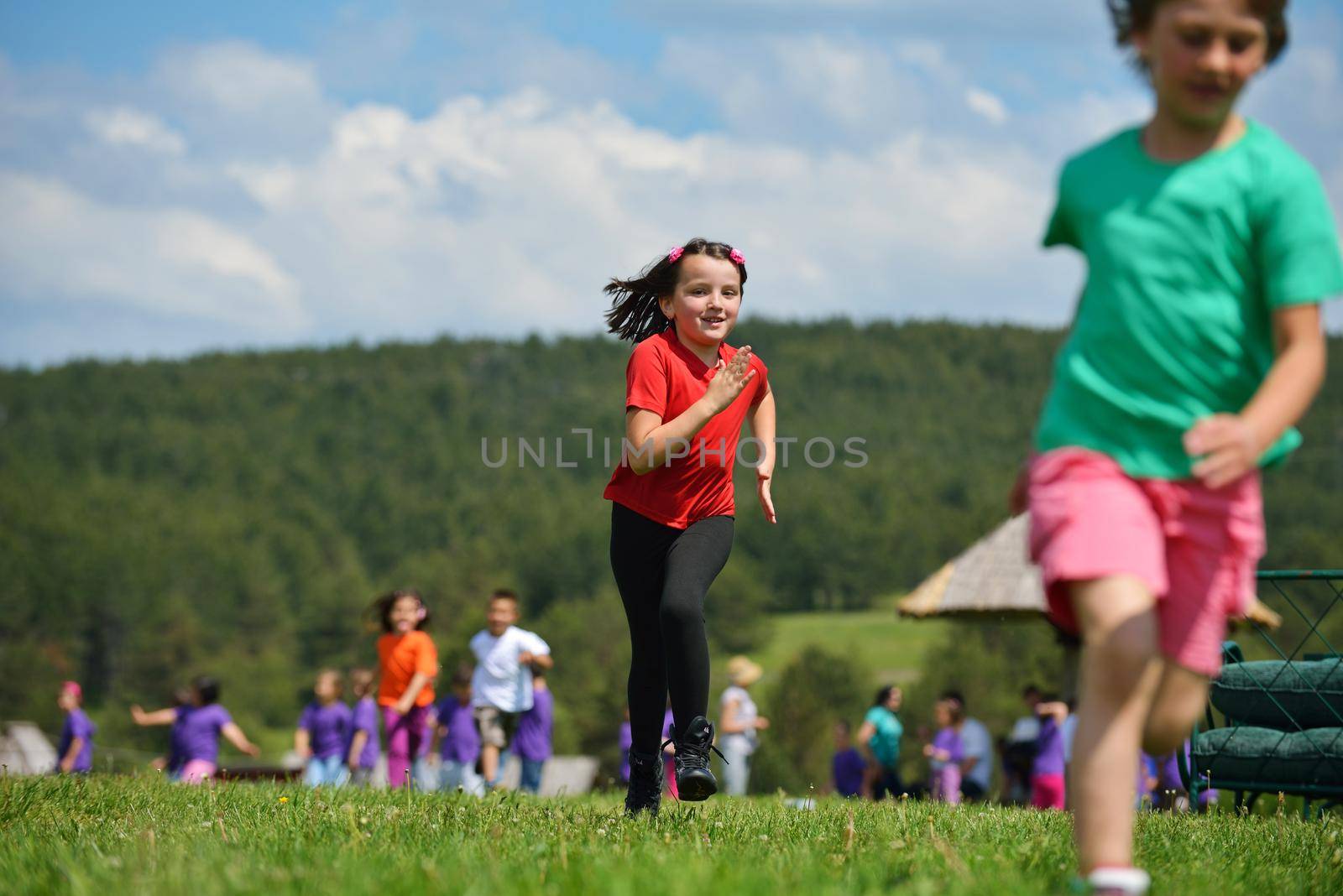 happy kids group have fun in nature outdoors park