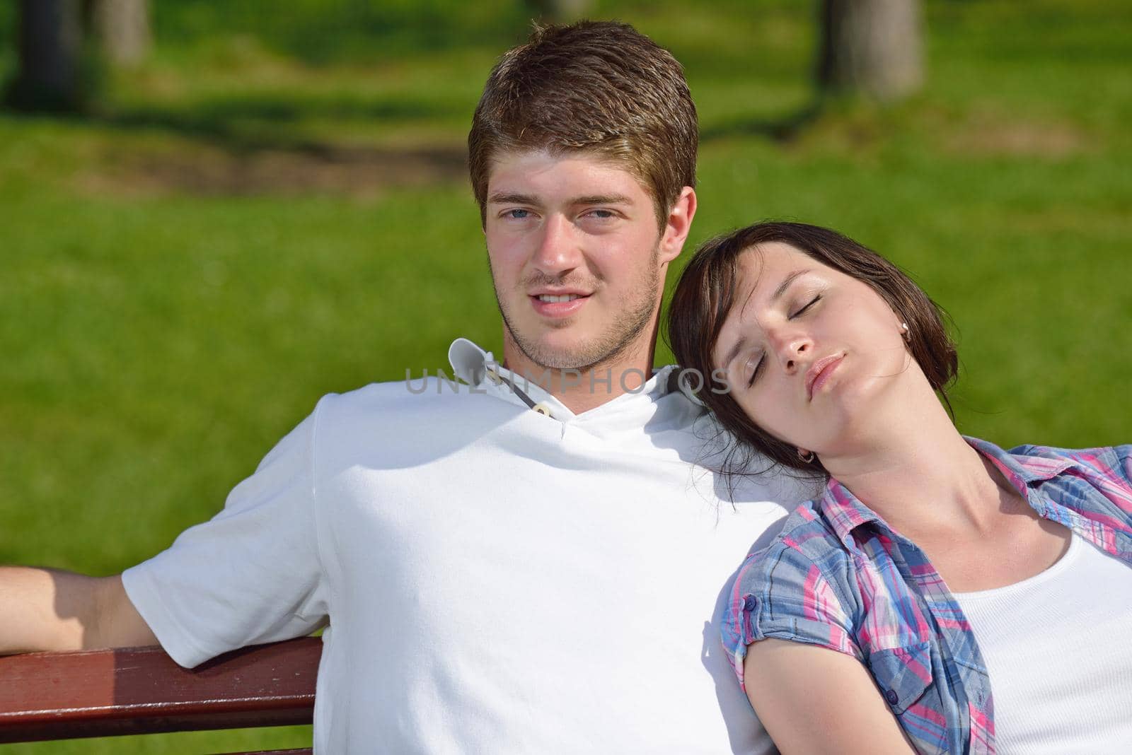 Portrait of romantic young couple in love  smiling together outdoor in nature with blue sky in background