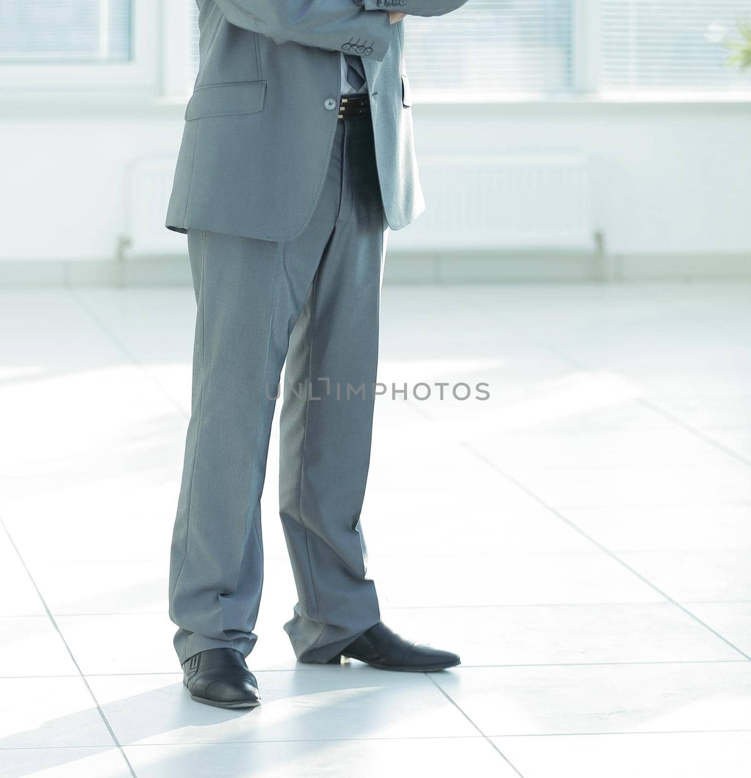 portrait of a successful Mature businessman in modern office. legs close up