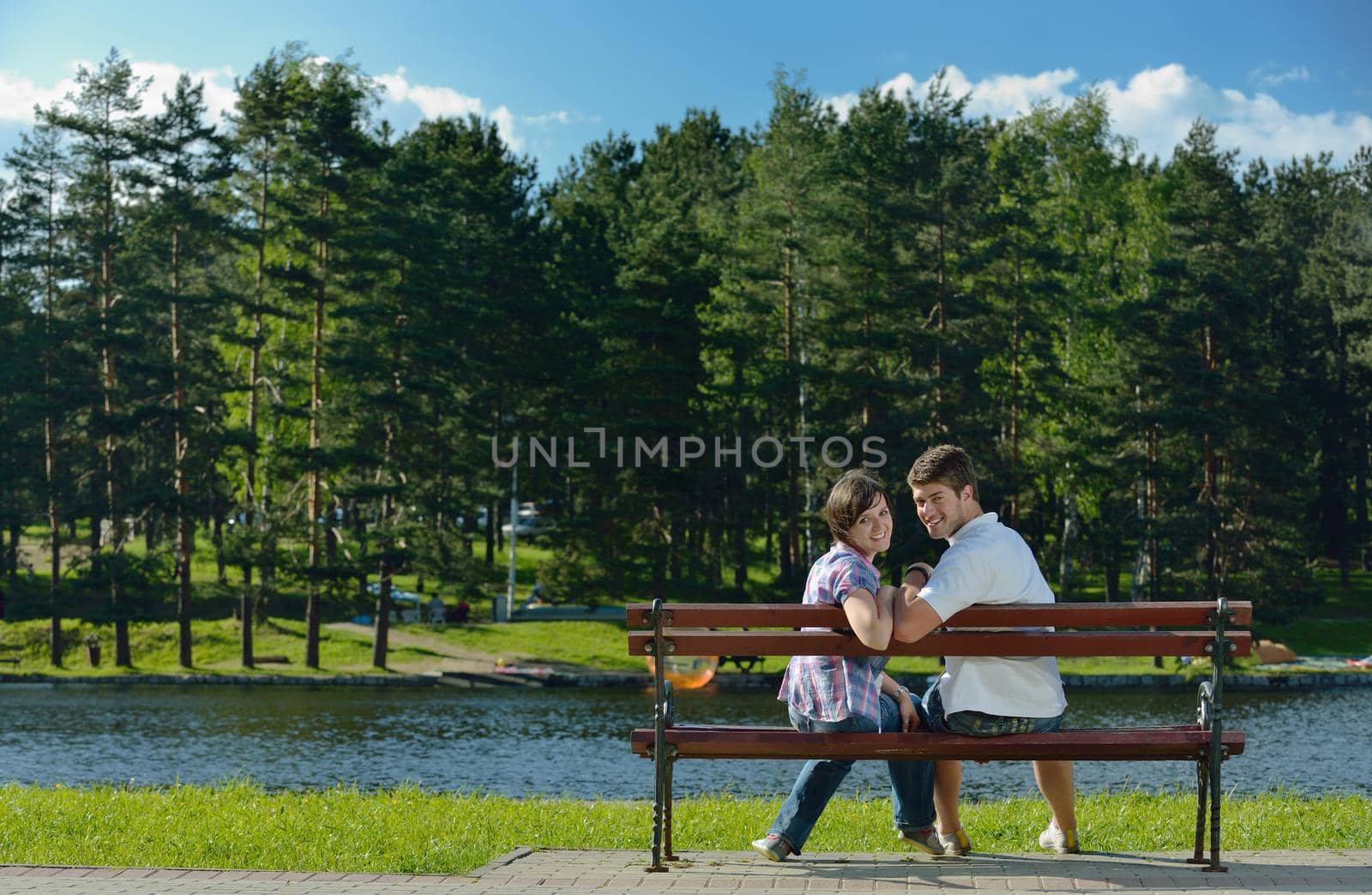 Portrait of romantic young couple in love  smiling together outdoor in nature with blue sky in background