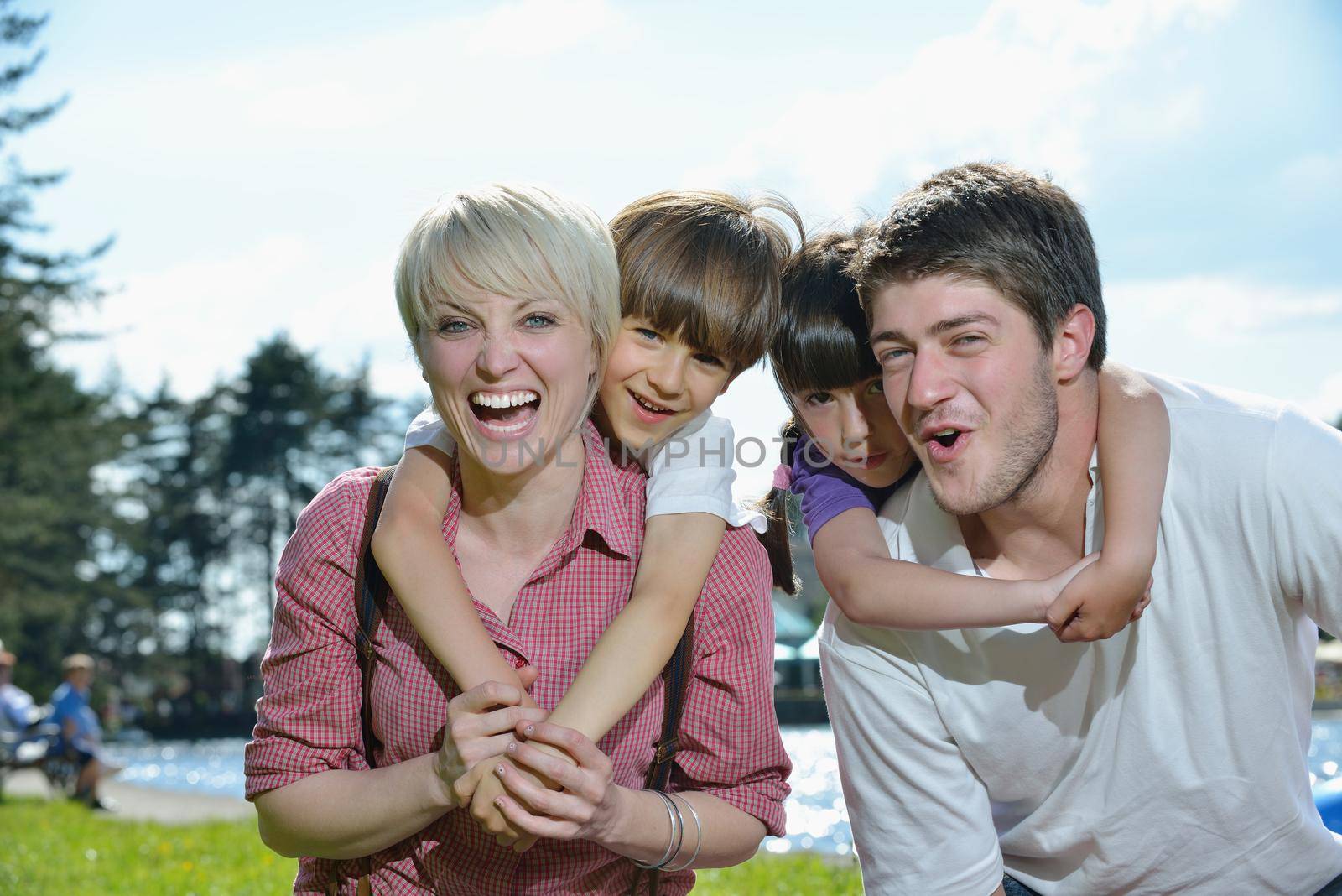 happy young family have fun outdoors by dotshock