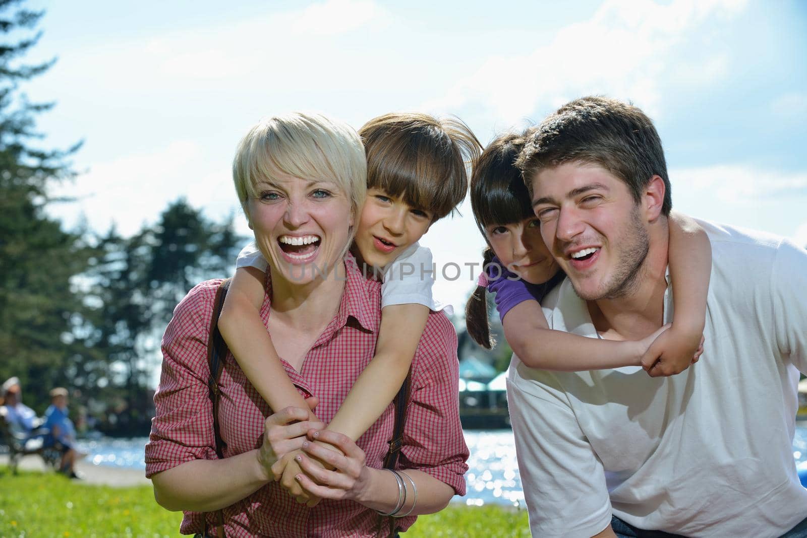 happy young family have fun outdoors by dotshock