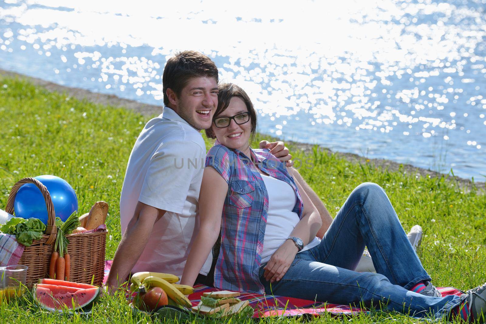 happy young romantic couple in love   having a picnic outdoor on a summer day