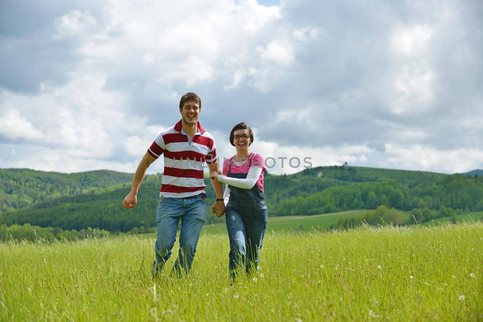 Portrait of romantic young couple in love  smiling together outdoor in nature with blue sky in background
