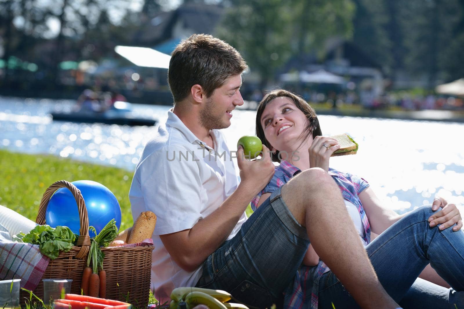 happy young romantic couple in love   having a picnic outdoor on a summer day