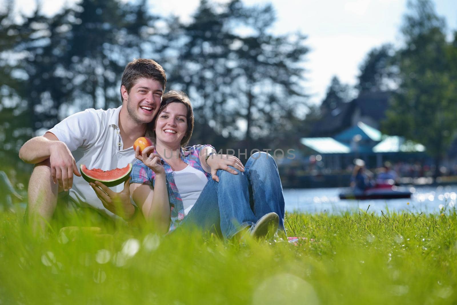 happy young romantic couple in love   having a picnic outdoor on a summer day