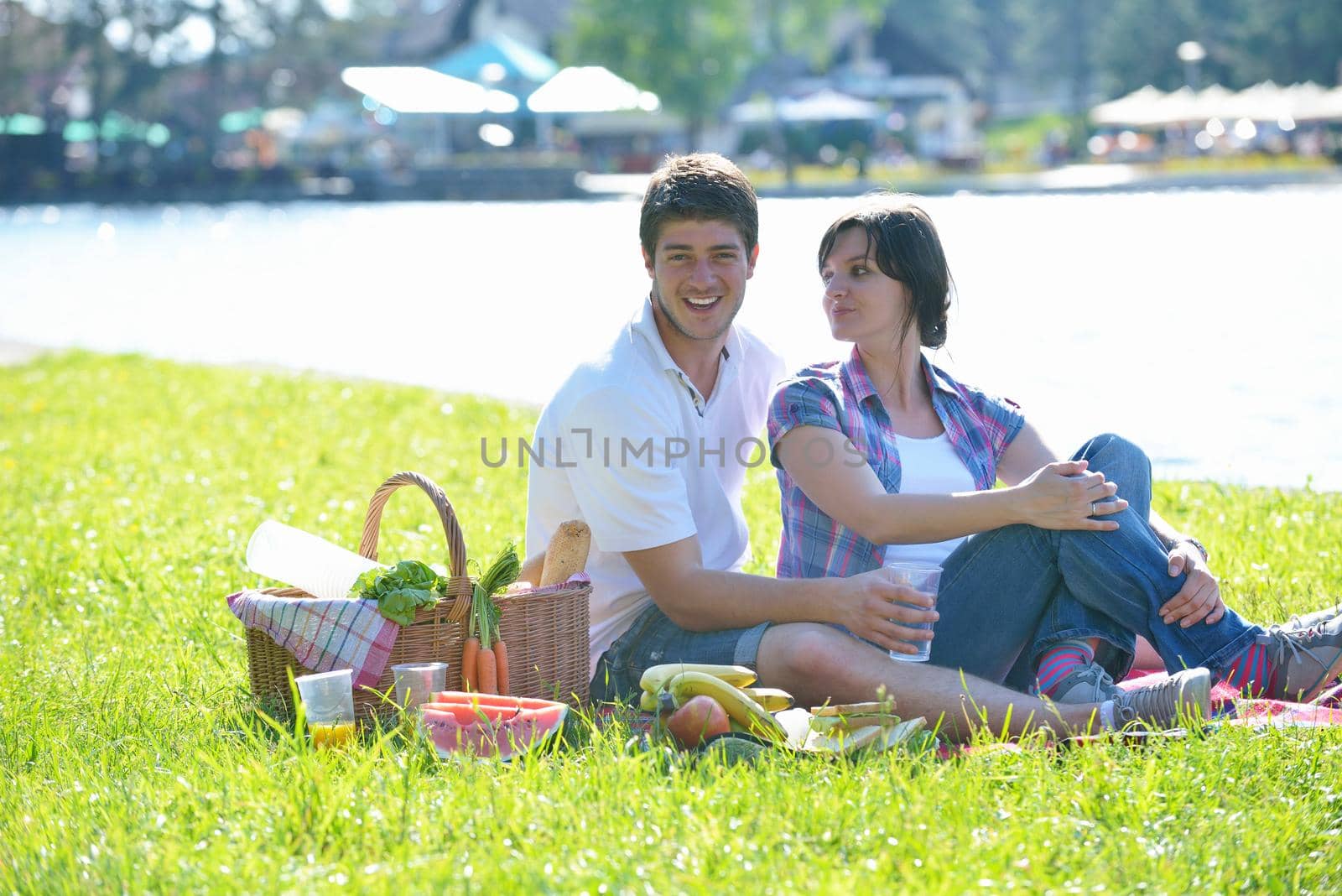 happy young romantic couple in love   having a picnic outdoor on a summer day