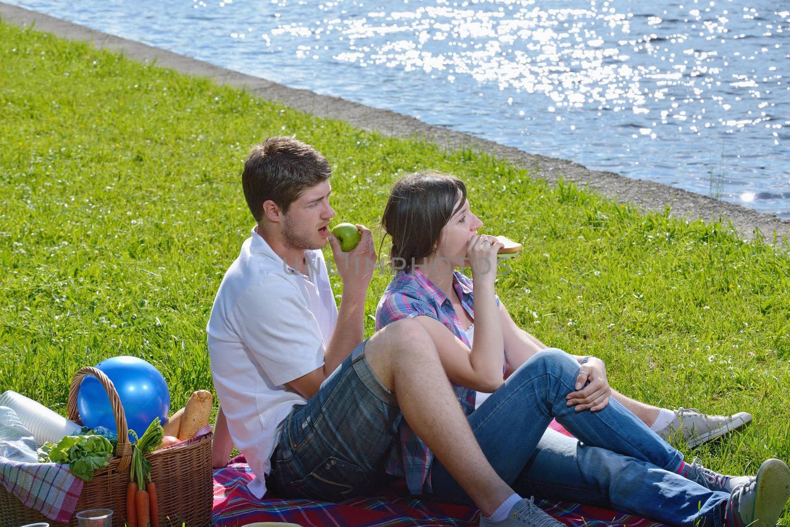 happy young romantic couple in love   having a picnic outdoor on a summer day