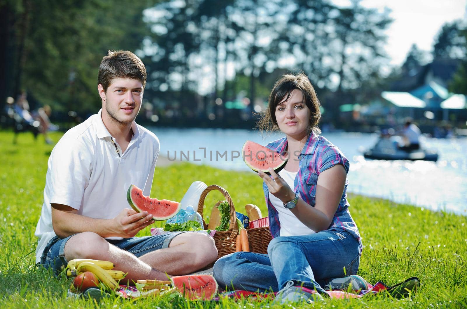 happy young romantic couple in love   having a picnic outdoor on a summer day