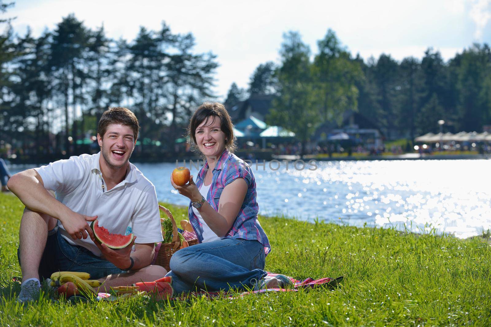 happy young romantic couple in love   having a picnic outdoor on a summer day