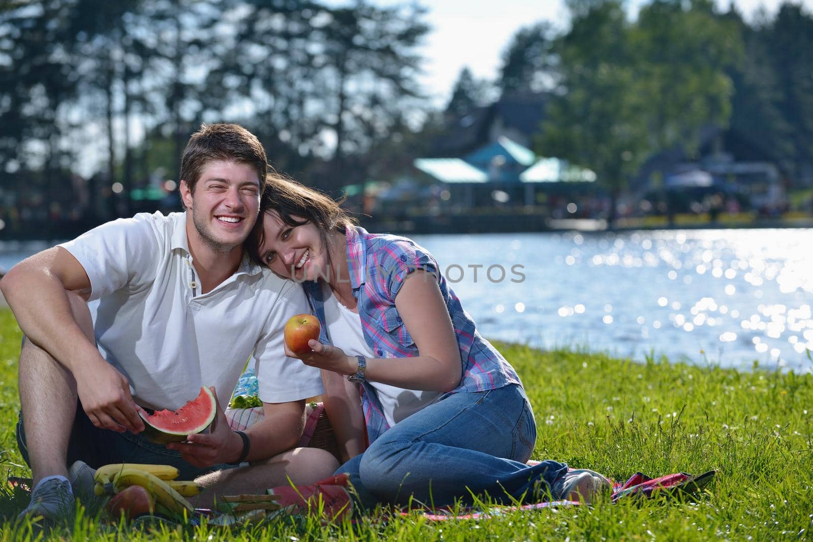 happy young romantic couple in love   having a picnic outdoor on a summer day