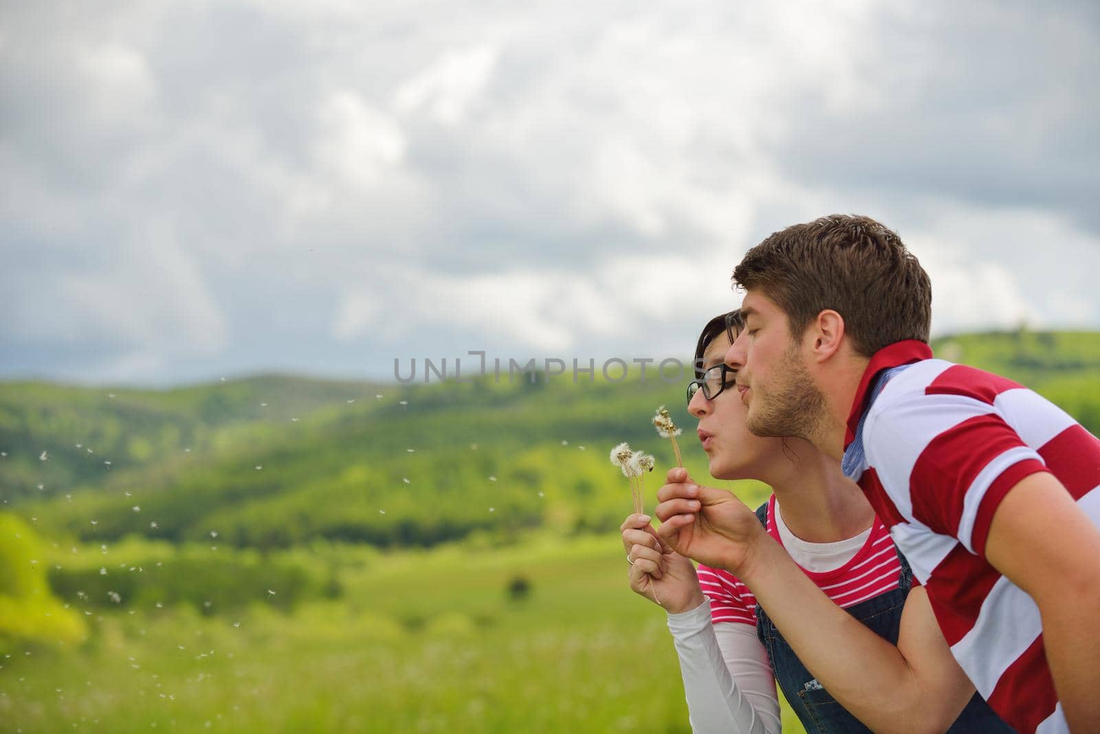 Portrait of romantic young couple smiling together outdoor by dotshock