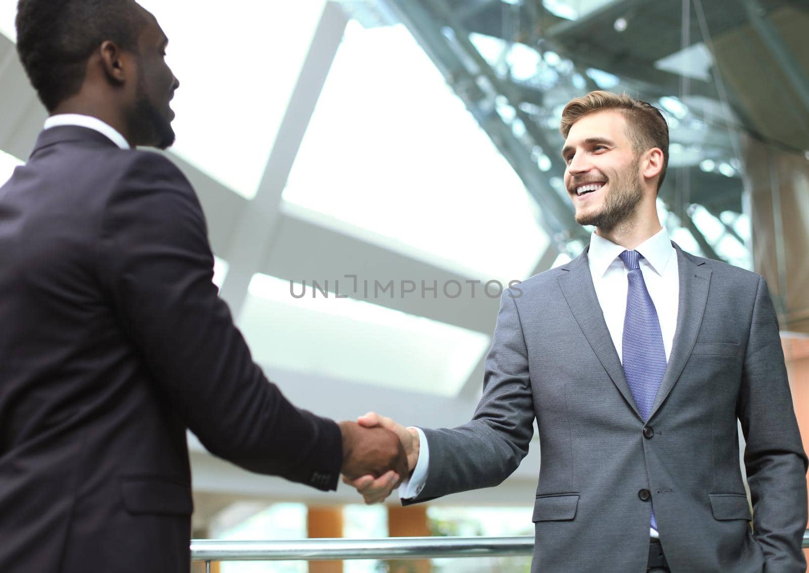 Business meeting. African American businessman shaking hands with caucasian businessman.