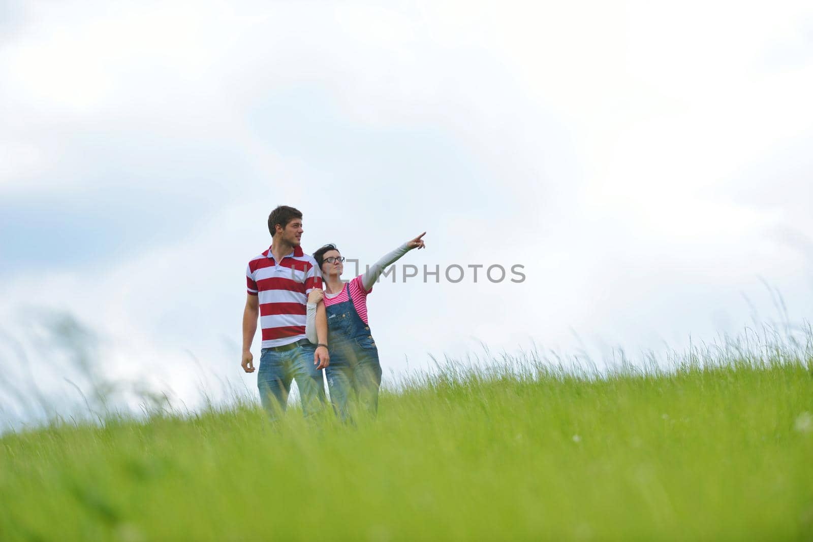 Portrait of romantic young couple smiling together outdoor by dotshock