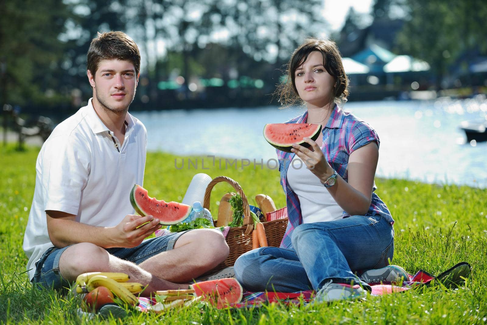 happy young romantic couple in love   having a picnic outdoor on a summer day