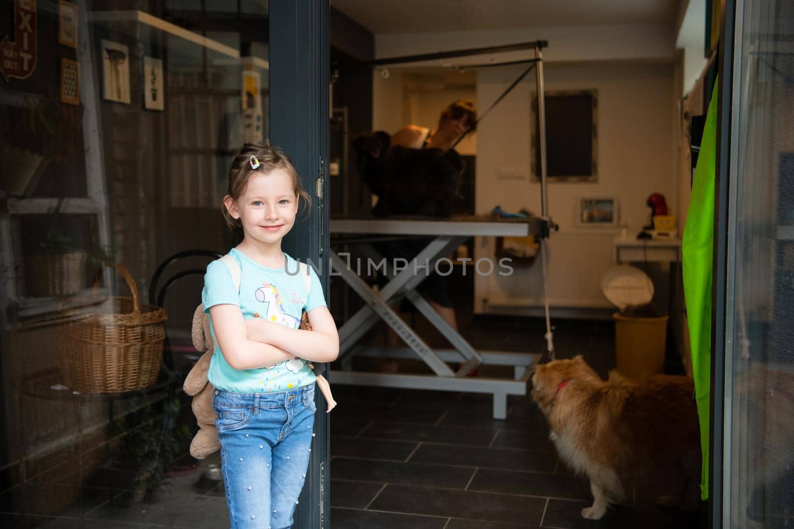 little cute girl standing in front of beauty salon for animals by dotshock