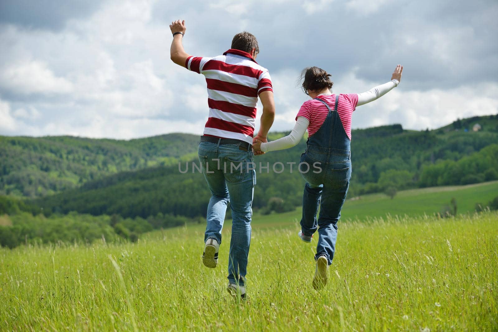 Portrait of romantic young couple in love  smiling together outdoor in nature with blue sky in background