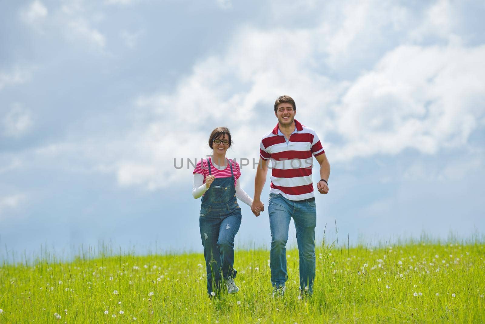 Portrait of romantic young couple in love  smiling together outdoor in nature with blue sky in background