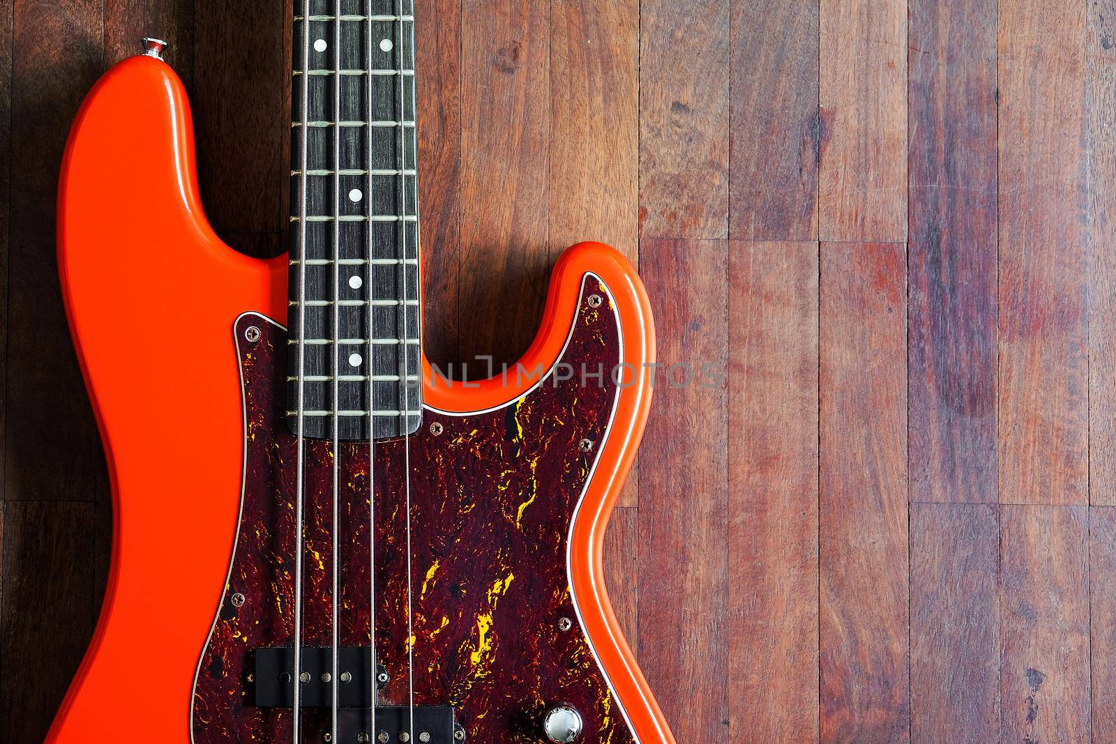 orange electric bass guitar by ponsulak