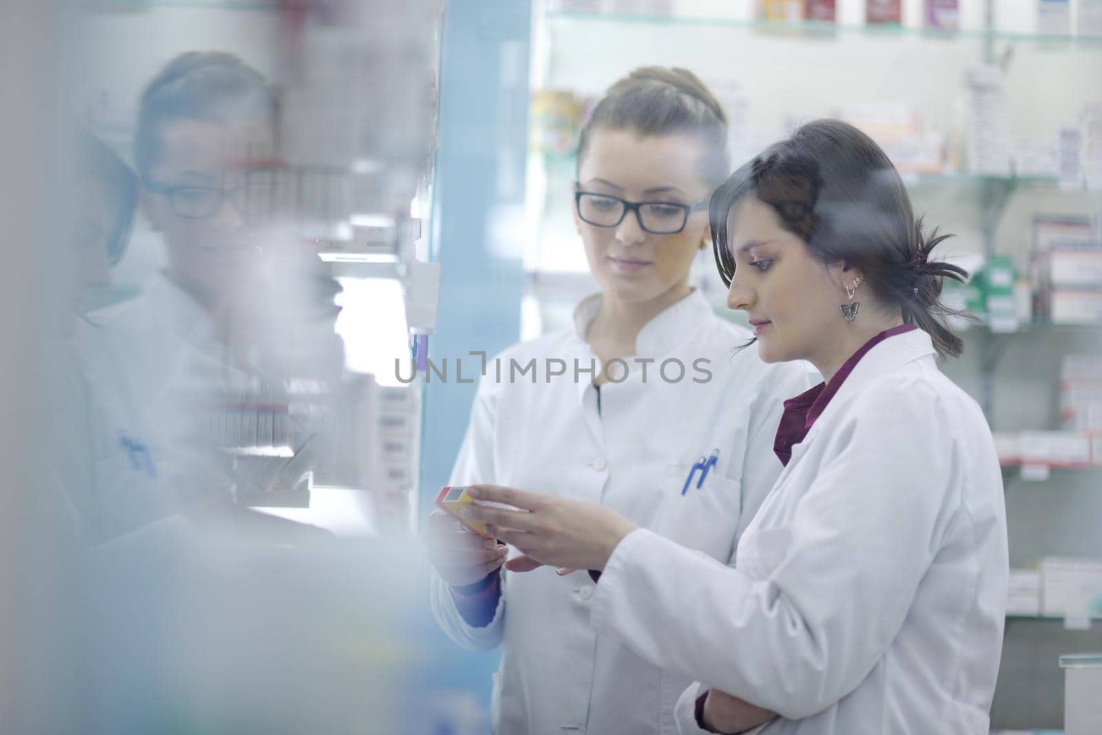 team of  pharmacist chemist woman group  standing in pharmacy drugstore