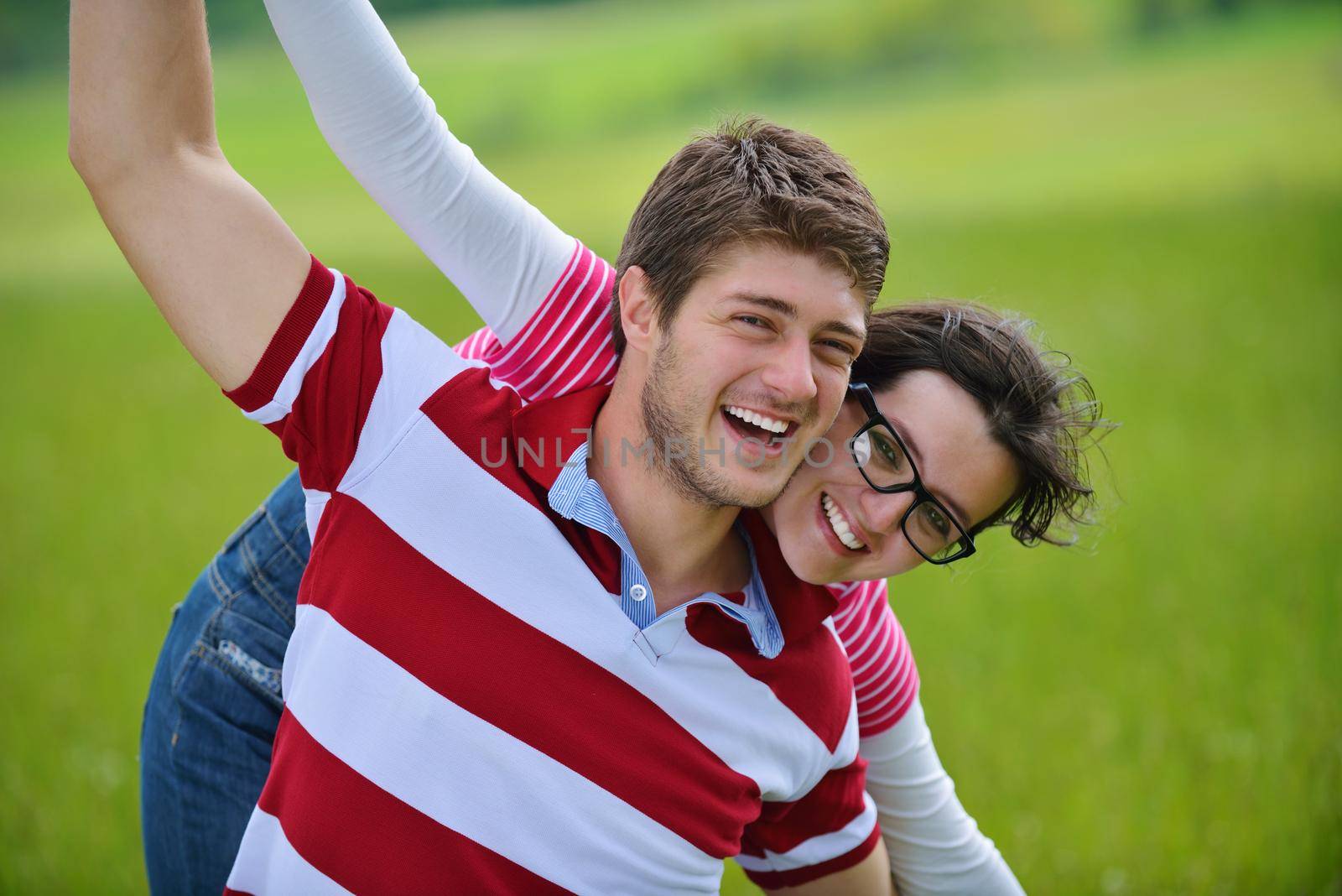 Portrait of romantic young couple in love  smiling together outdoor in nature with blue sky in background