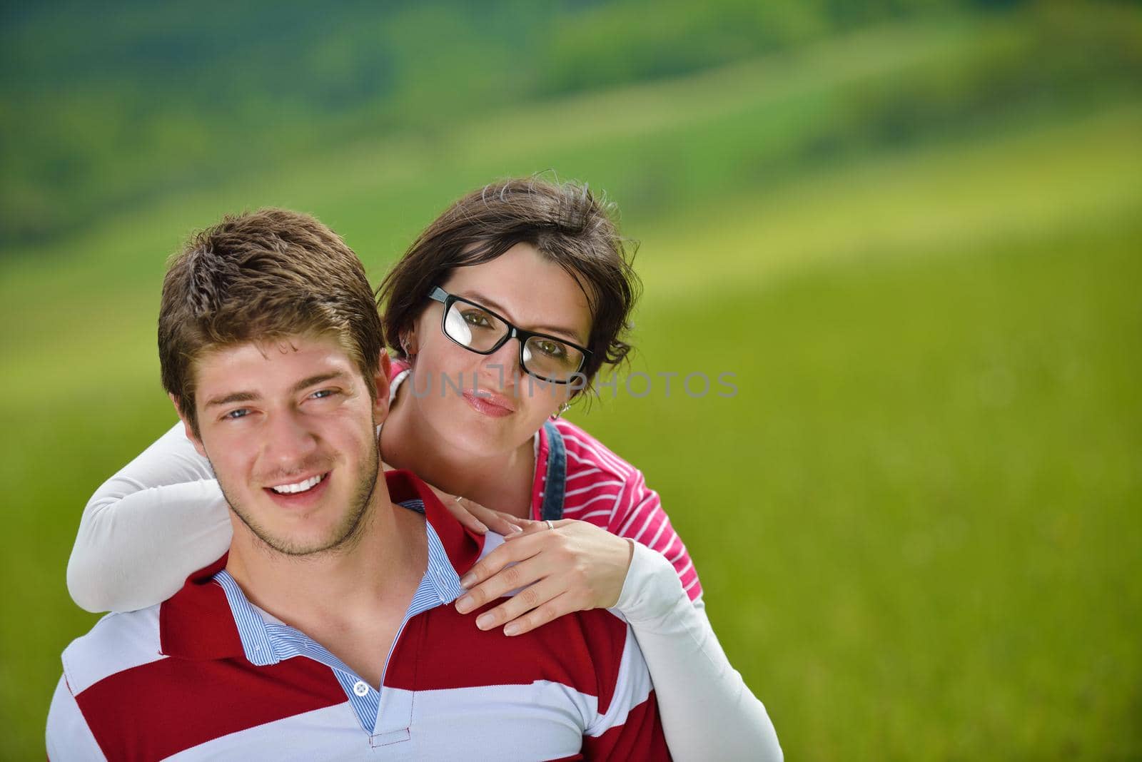 Portrait of romantic young couple in love  smiling together outdoor in nature with blue sky in background