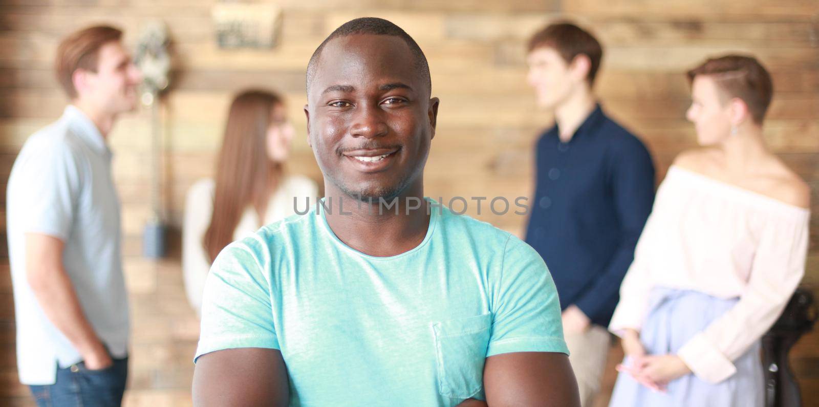 Confident successful black business man in front of group of people.