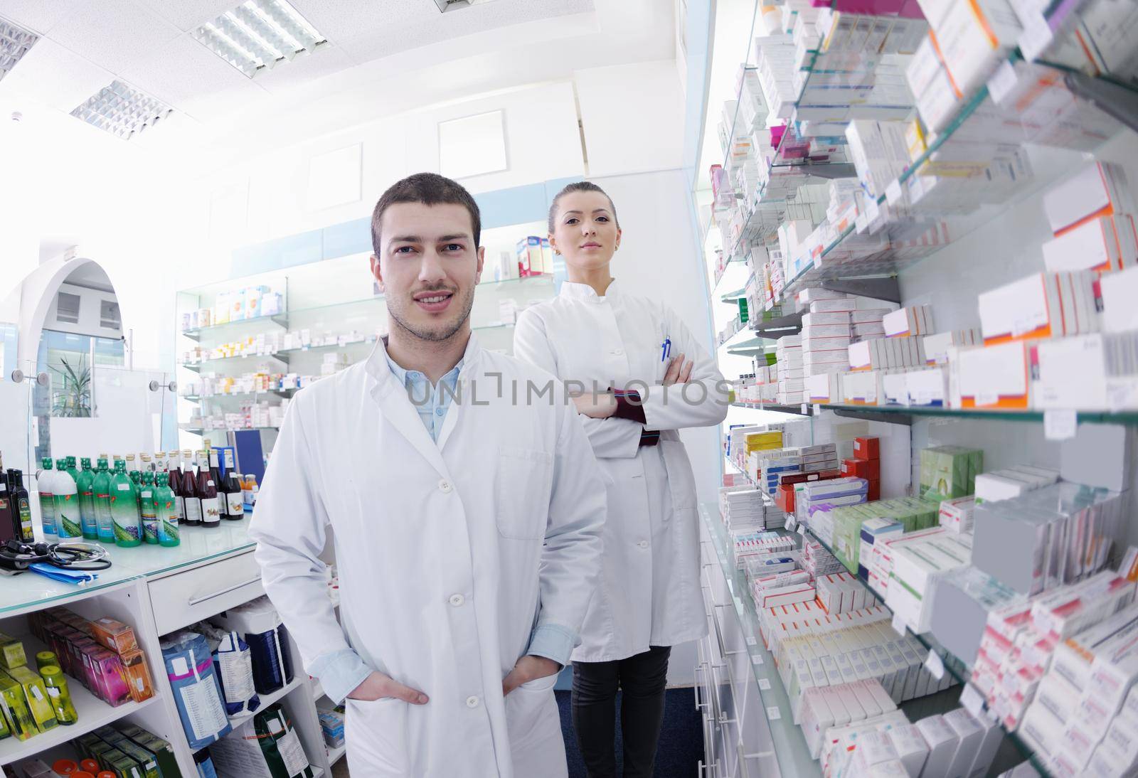 team of  pharmacist chemist woman and man  group  standing in pharmacy drugstore