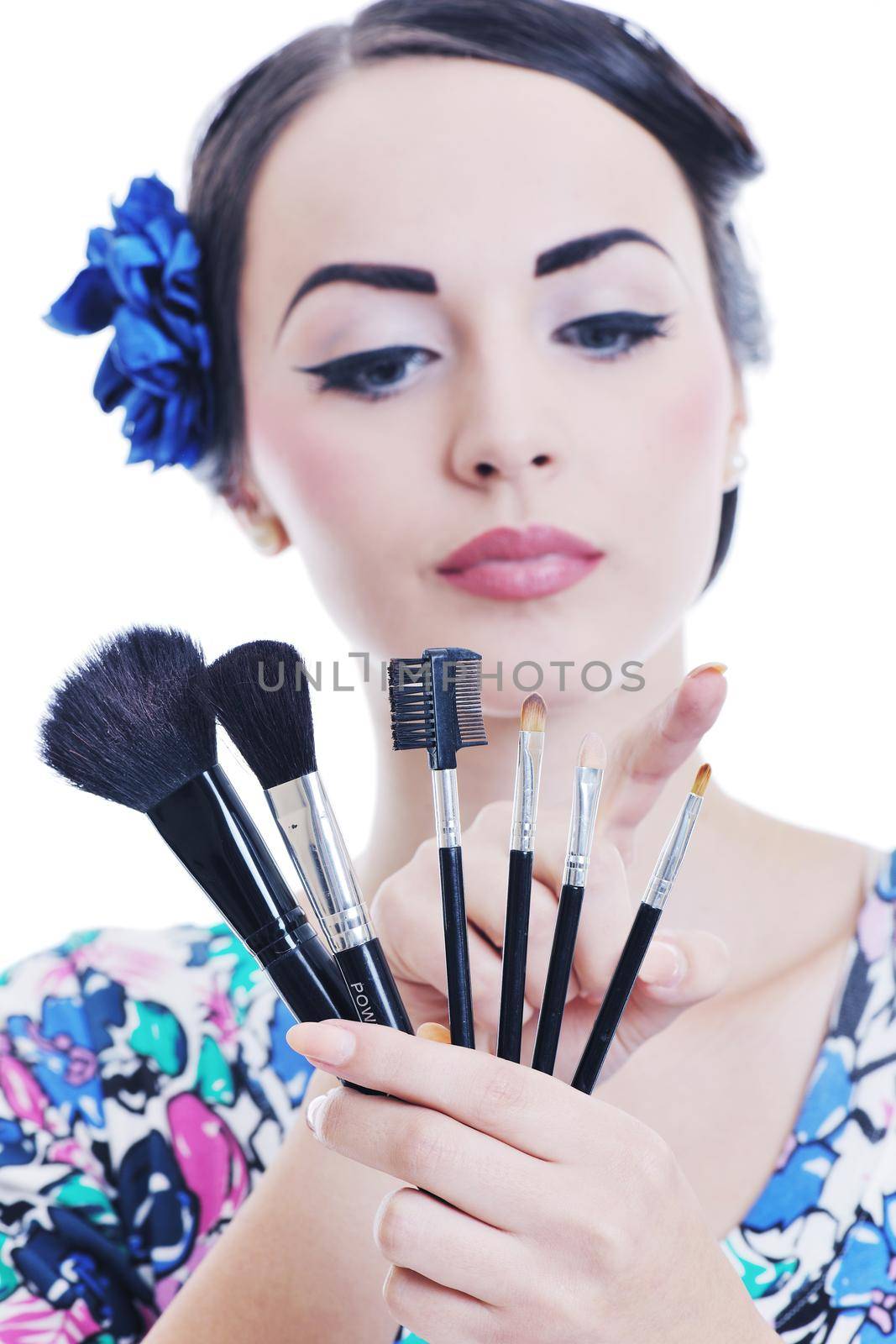 beautiful young pinup  woman apply makeup and cosmetics beauty treatment isolated on white in studio