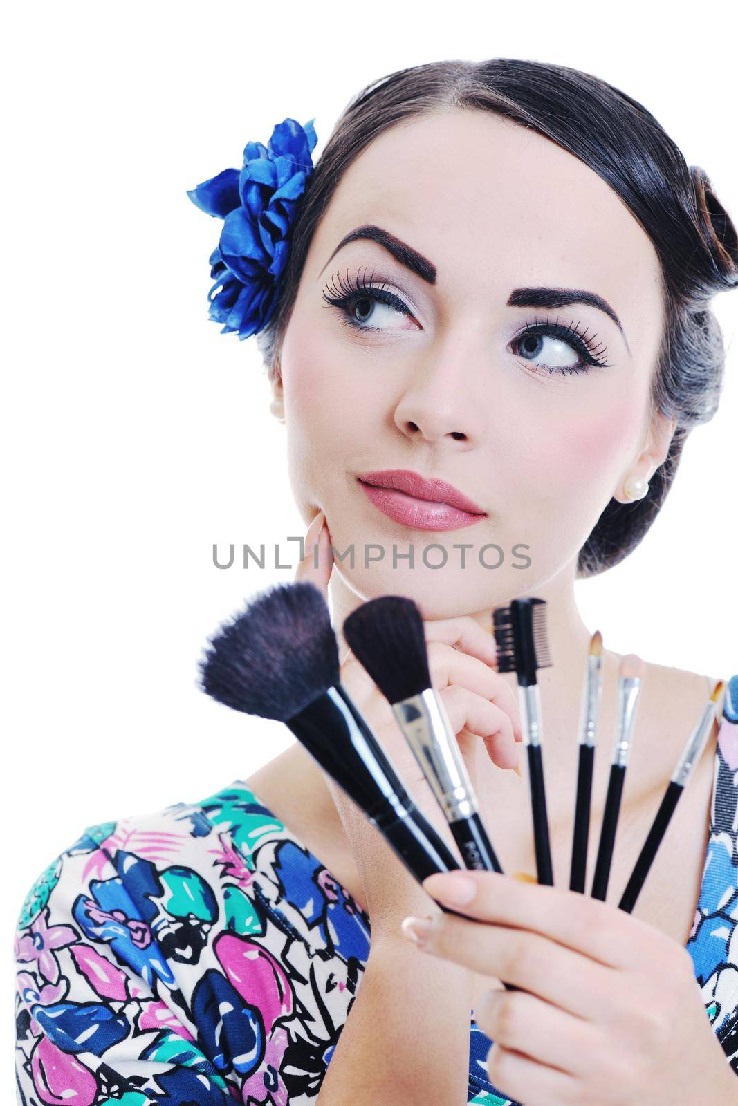 beautiful young pinup  woman apply makeup and cosmetics beauty treatment isolated on white in studio