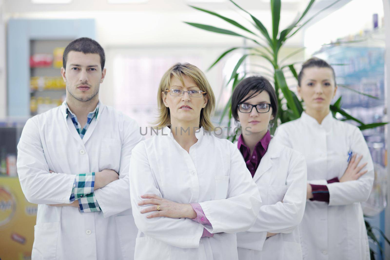 team of  pharmacist chemist woman and man  group  standing in pharmacy drugstore