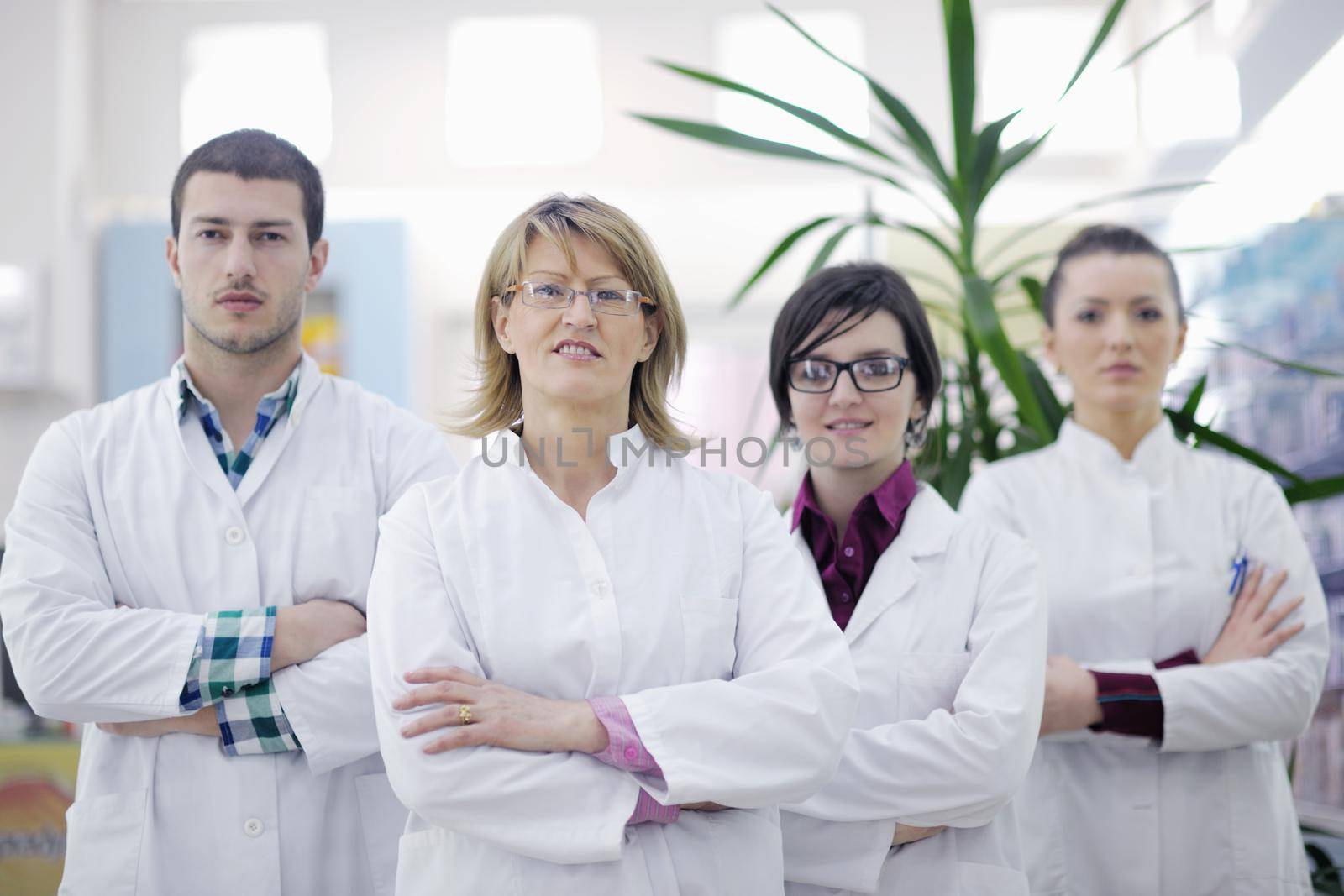 team of  pharmacist chemist woman and man  group  standing in pharmacy drugstore