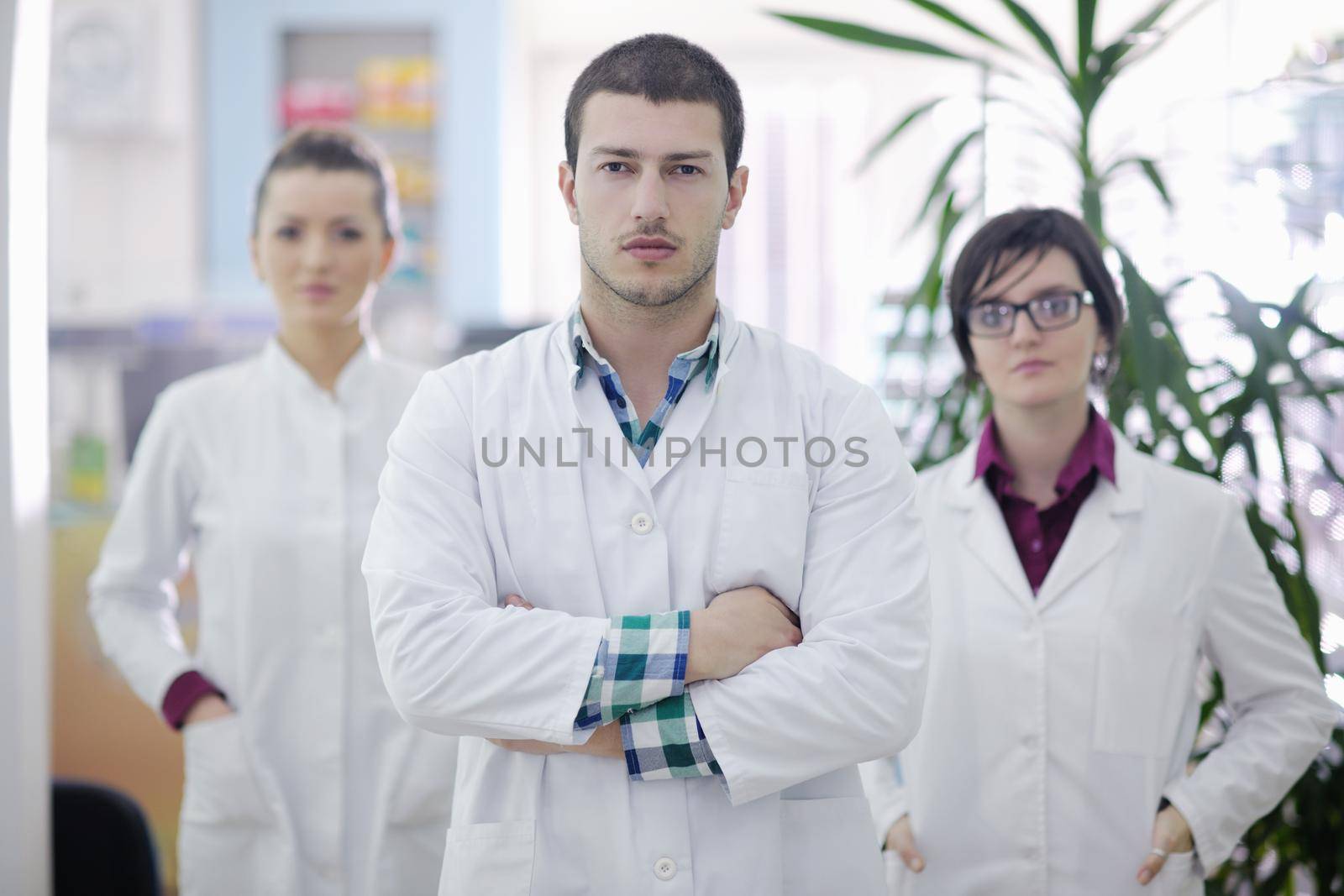 team of  pharmacist chemist woman and man  group  standing in pharmacy drugstore