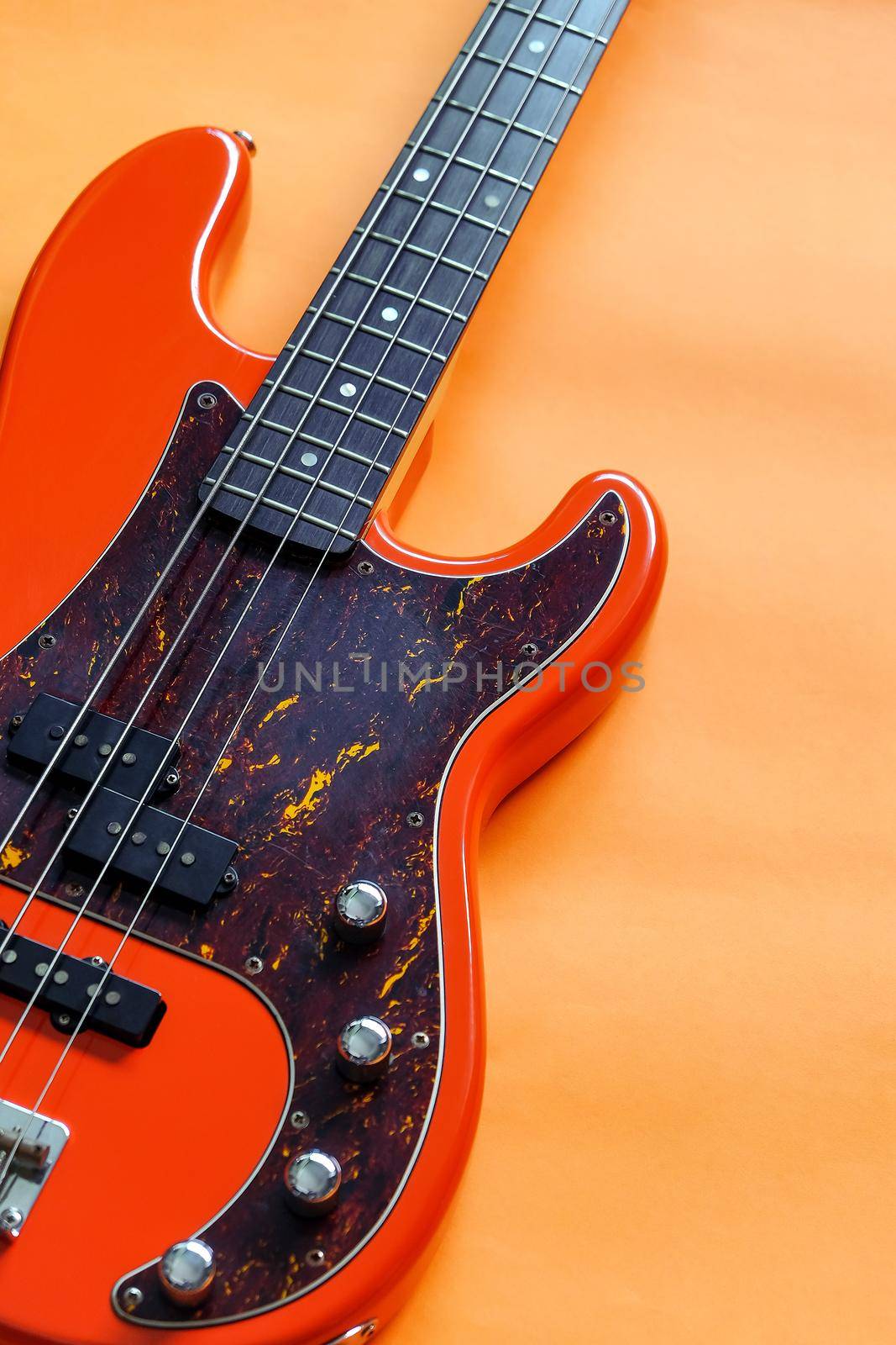 orange electric bass guitar by ponsulak