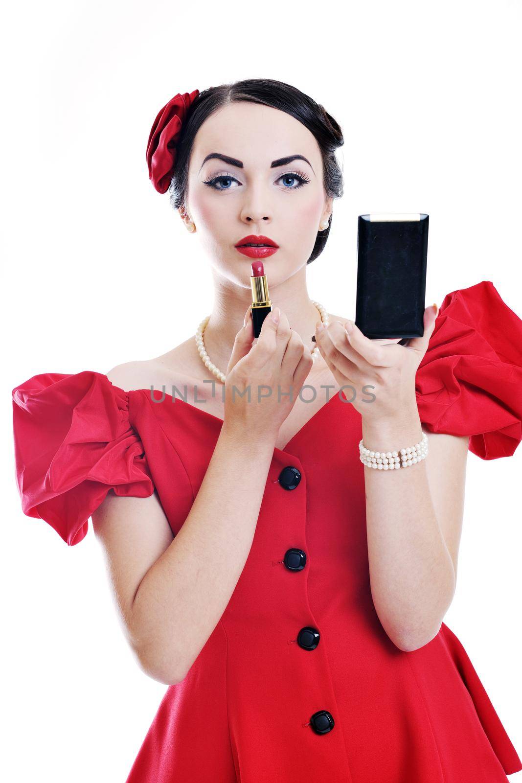 beautiful young pinup  woman apply makeup and cosmetics beauty treatment isolated on white in studio