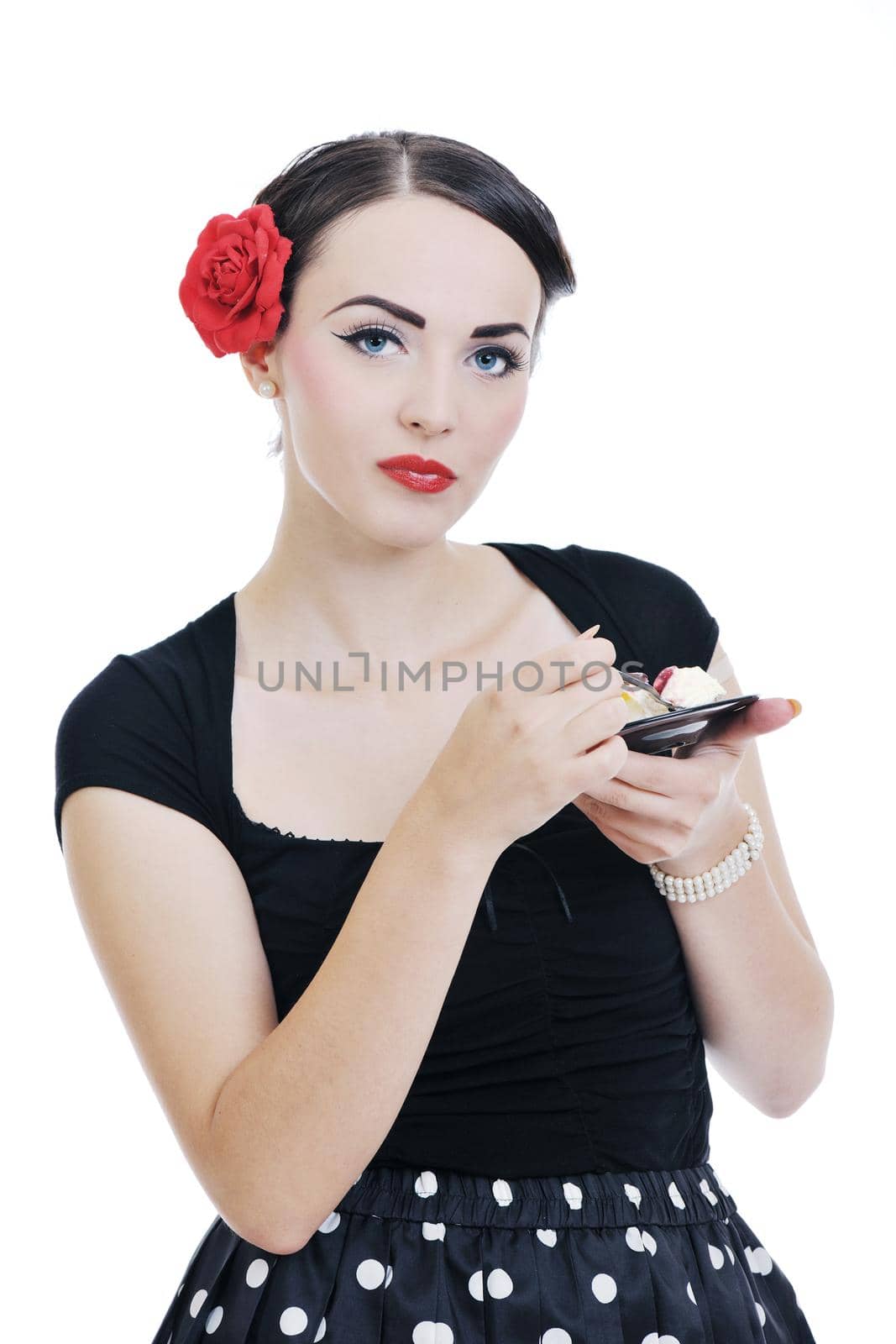 beautiful young retro pinup  woman eat sweet cake food isolated on white iin studio, representing diet and healthy concept