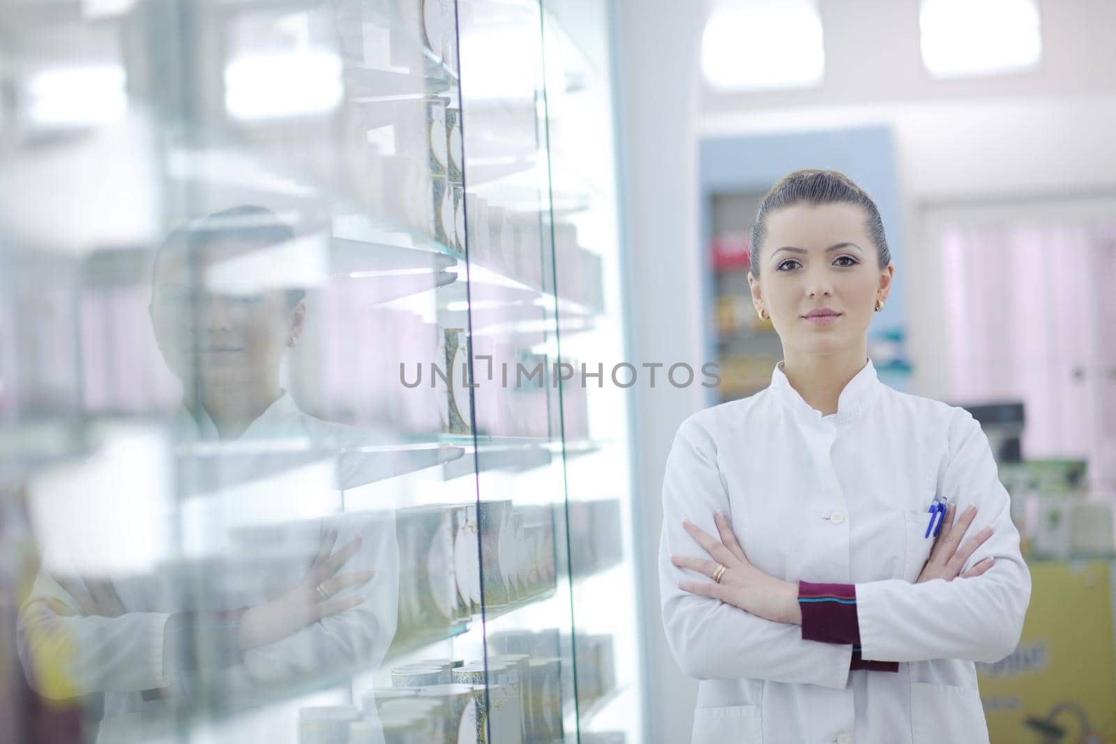 Happy cheerful pharmacist chemist woman standing in pharmacy drugstore