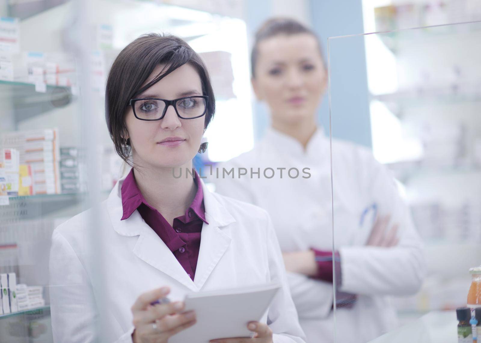 team of  pharmacist chemist woman group  standing in pharmacy drugstore